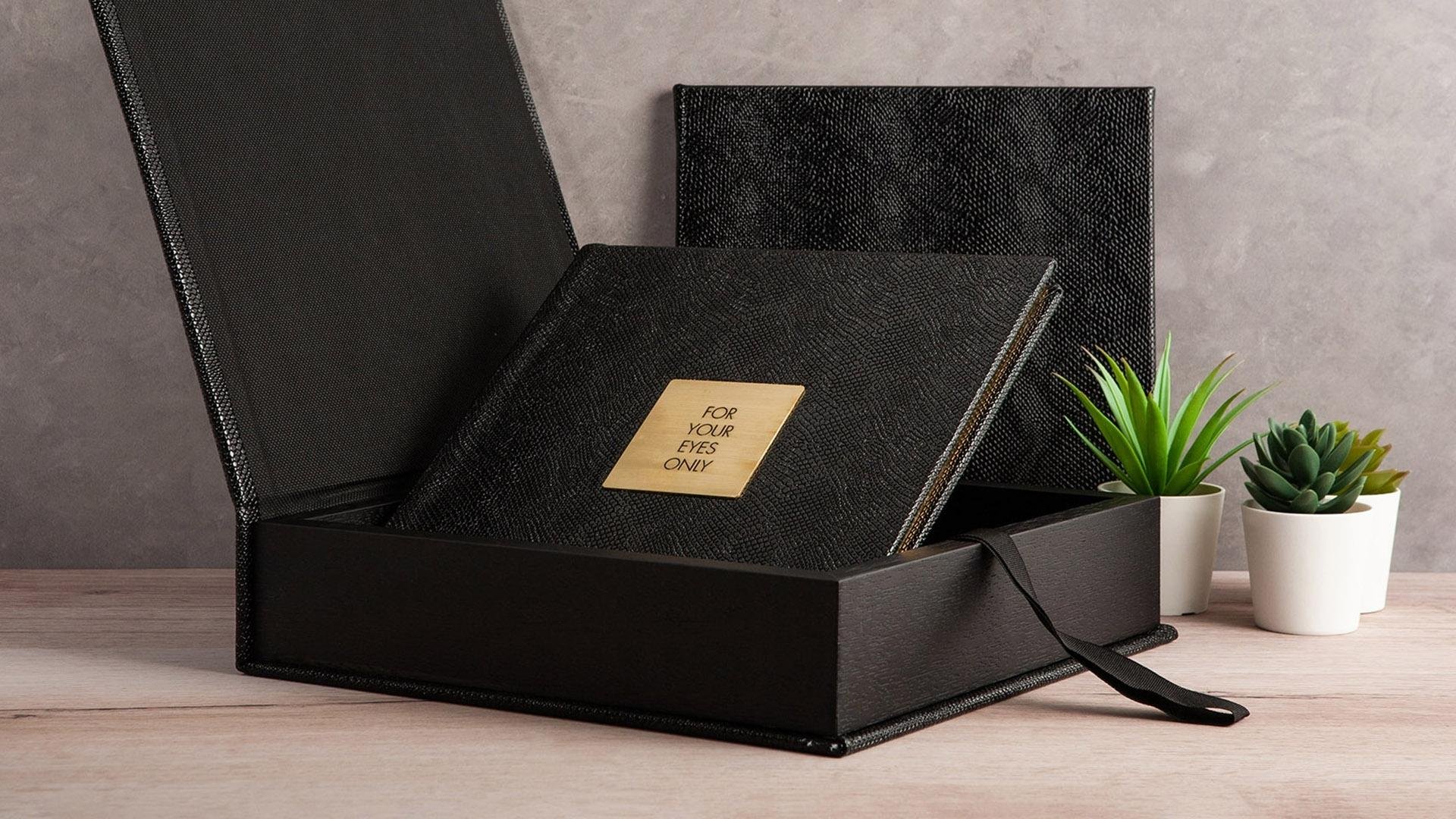 A beautiful photo album for boudoir portraits with a plaque that says For Your Eyes Only